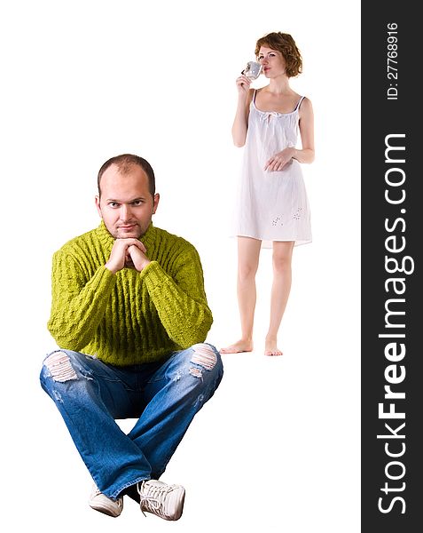 Thoughtful guy in the foreground, and a girl with a cup in his hand, isolated on white background