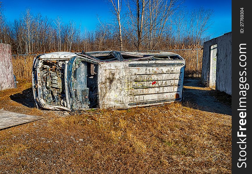 A old car in a paint ball area. A old car in a paint ball area