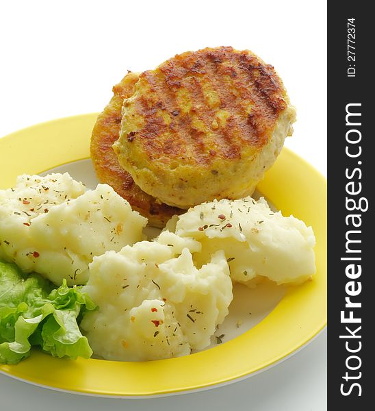 Mashed Potato and Meat Cutlets with Lettuce on Yellow Plate closeup. Mashed Potato and Meat Cutlets with Lettuce on Yellow Plate closeup