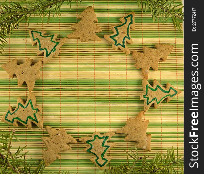 Christmas cookies in the form of circle on the green stripped background. Christmas cookies in the form of circle on the green stripped background