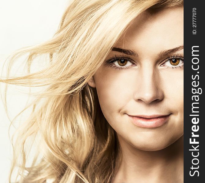 Fashion portrait of young beautiful woman posing in studio