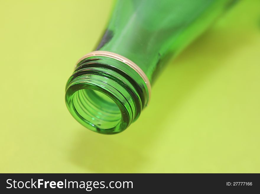 Mouth of green bottle over green background