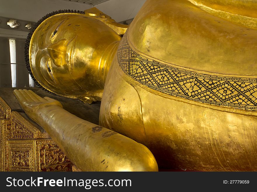 The Big golden Reclining Buddha in the important temple in Phrae, Thailand.