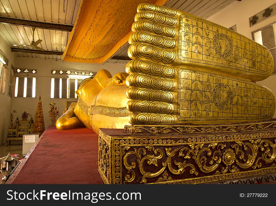 The Big golden Reclining Buddha in the important temple in Phrae,Thailand.