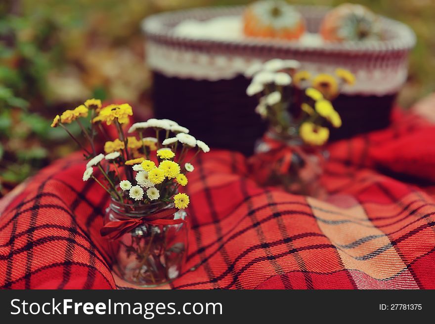 On a red blanket two bouquets of autumn colors. On a red blanket two bouquets of autumn colors