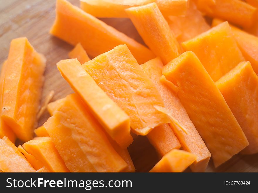 A pile of small pieces of carrot cut before being cooked. A pile of small pieces of carrot cut before being cooked