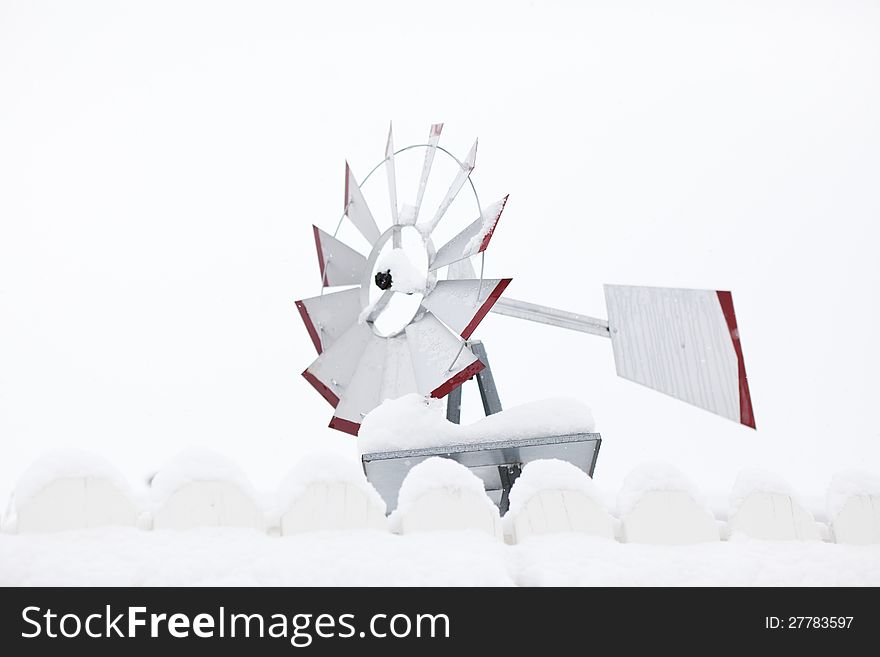 A windmill stands still on a snowy winter day.  Shallow depth of field. A windmill stands still on a snowy winter day.  Shallow depth of field.