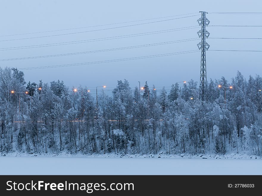 Powerlines and snowy trees in a wintry landscape in Tampere, Finland
