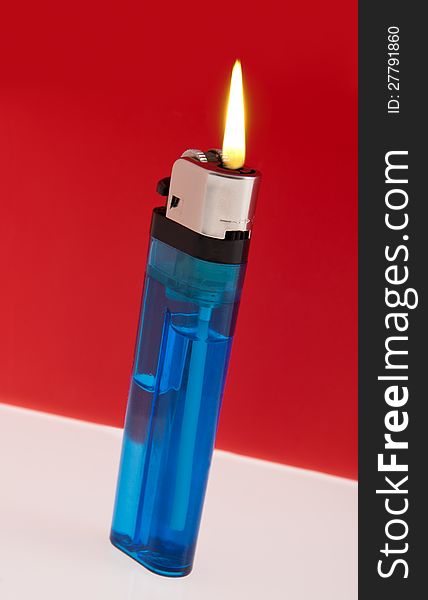 Burning lighter on table top. Burning lighter on table top