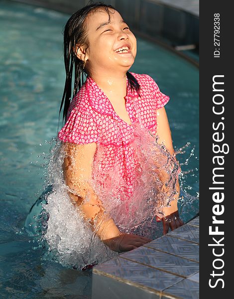 Smiling Asian Girl Playing in the Water