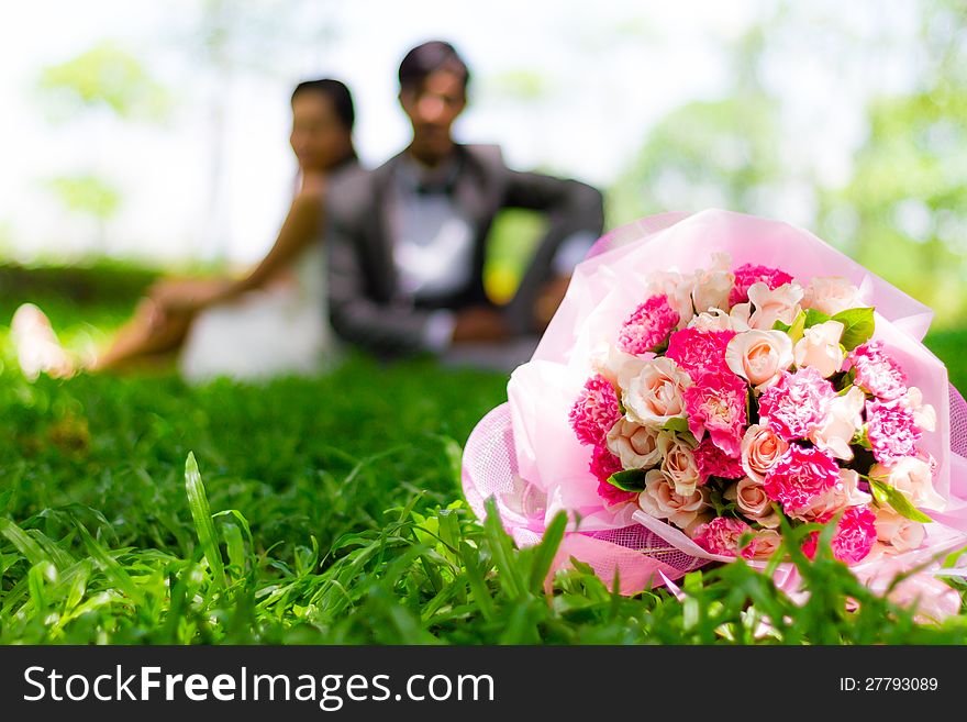 Wedding couple, with a bouquet of flowers