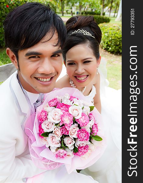 Wedding couple, with a bouquet of flowers