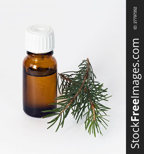 Two viales with essential oils and sprigs of spruce. Two viales with essential oils and sprigs of spruce