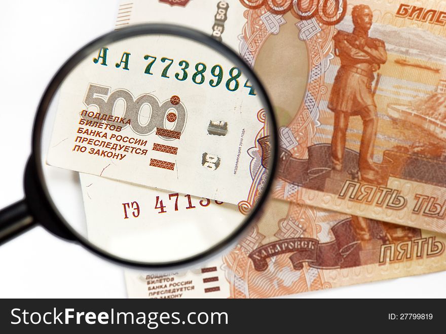 Magnifier on banknotes close-up