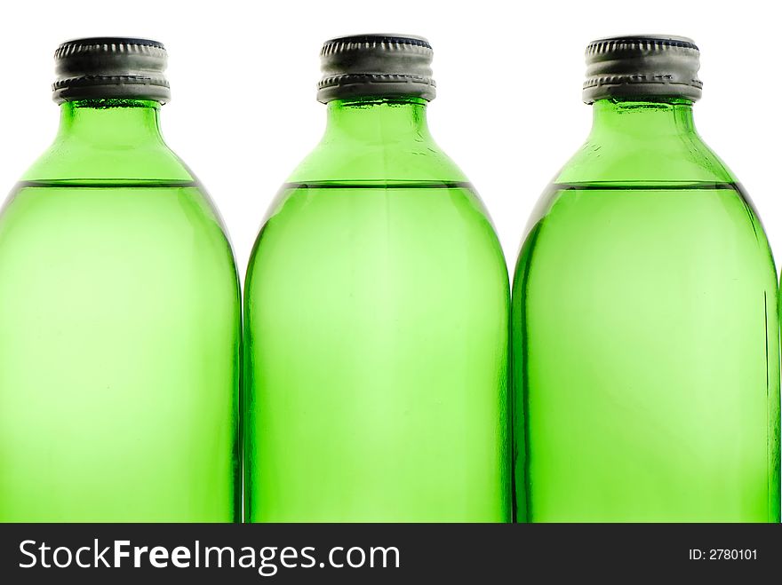 Three bottles green color with mineral water on white background