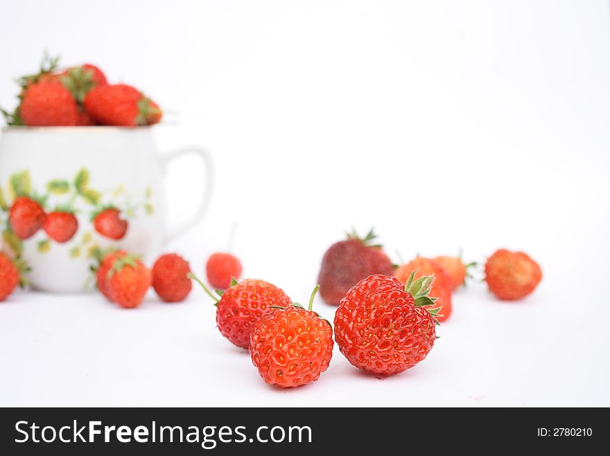 Strawberries in the small pot on white background. Strawberries in the small pot on white background