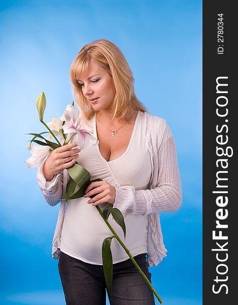 The fine pregnant woman with a bouquet of flowers in hands. The fine pregnant woman with a bouquet of flowers in hands