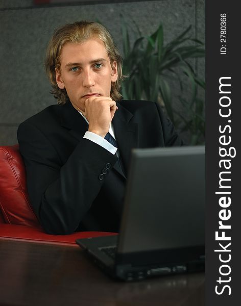 Young businessman with computer in his office. Young businessman with computer in his office
