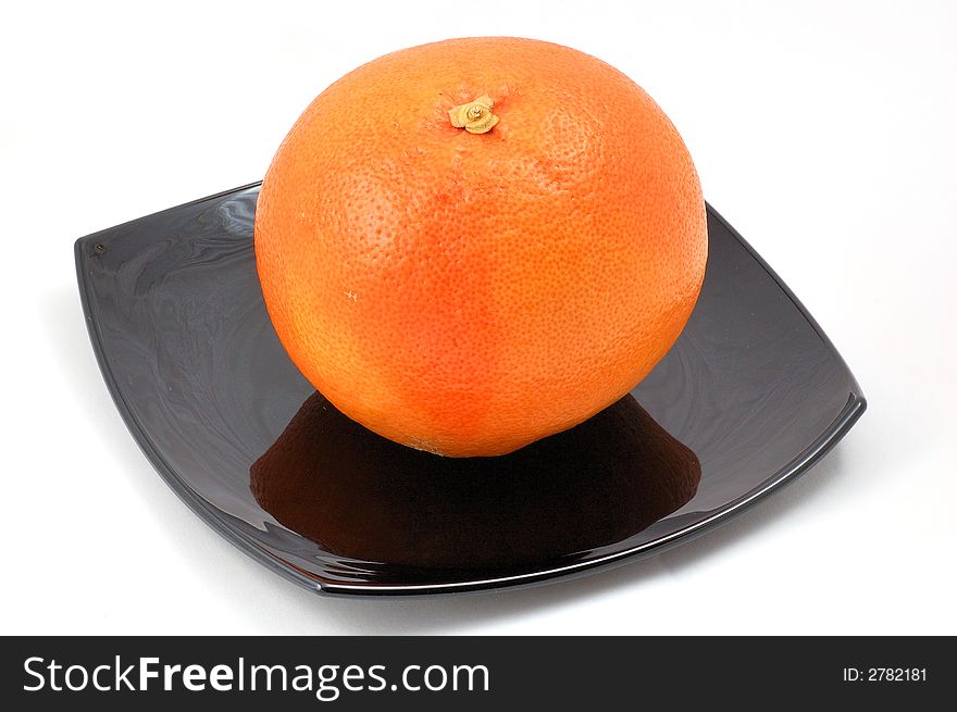 Grapefruit on the plate isolated