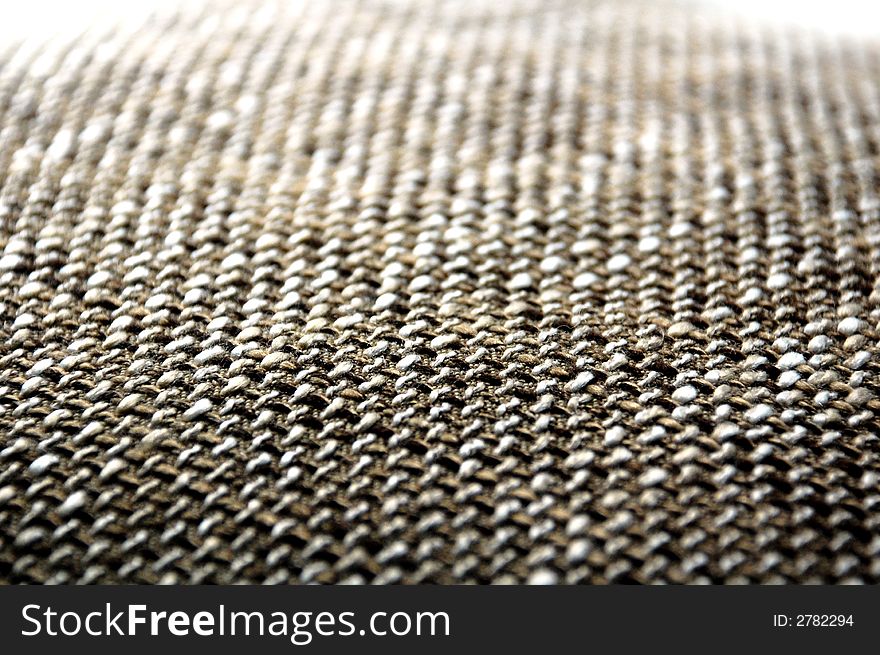 A brown grey texture from a pillow. A brown grey texture from a pillow