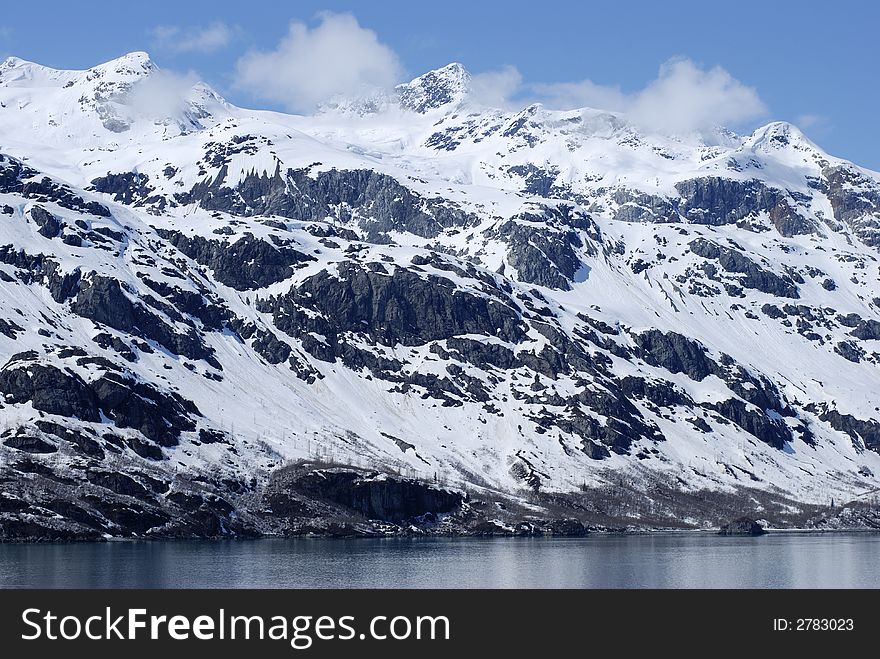 Mountainous snow-covered coast in Glacier Bay national park, Alaska. Mountainous snow-covered coast in Glacier Bay national park, Alaska.