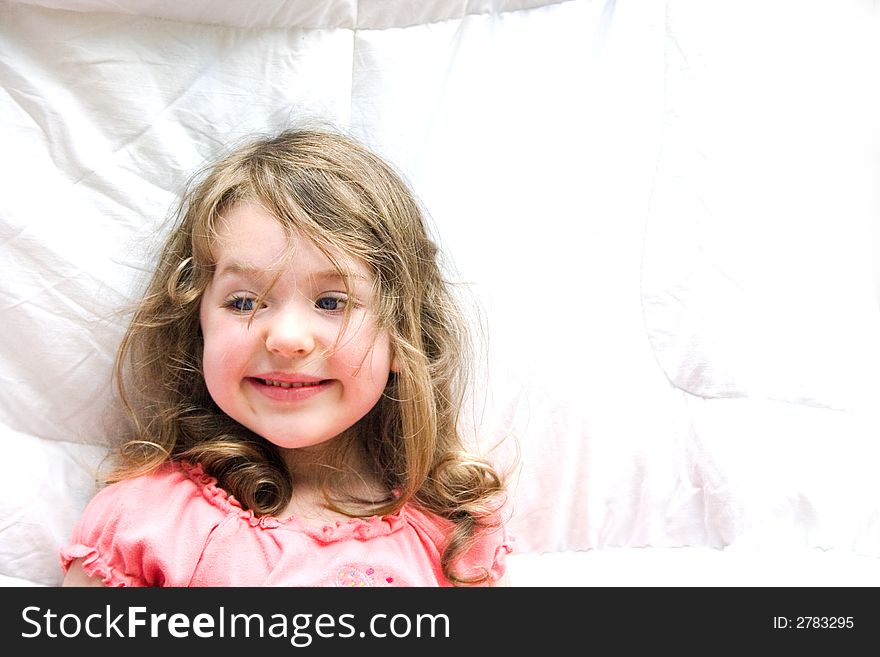 A little smiling girl against a white background. A little smiling girl against a white background