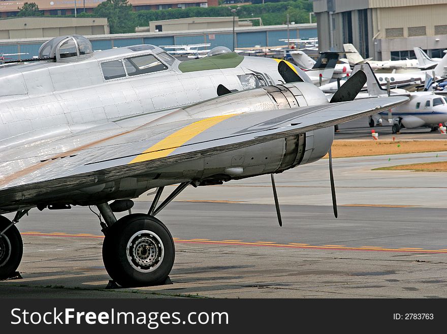 An old military prop plane at an airport