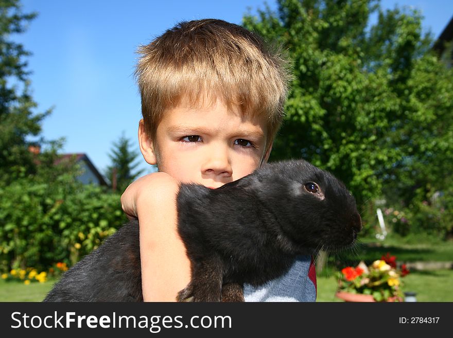 Young boy having a tender moment with his bunny. Young boy having a tender moment with his bunny