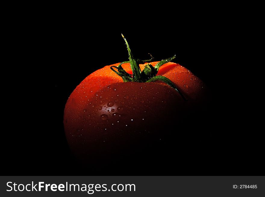 Image of fresh tomato with water drops.