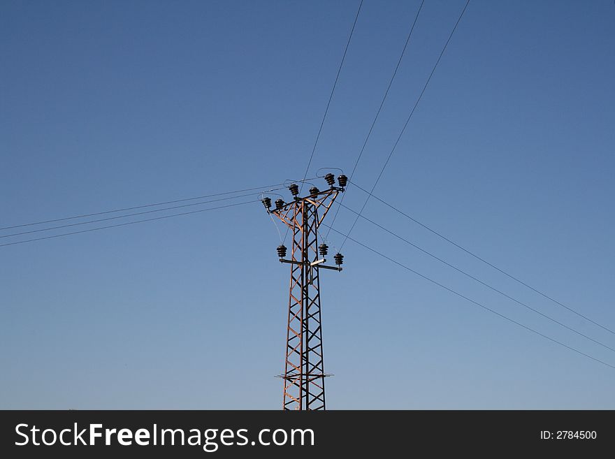 Power lines goes to three sides with blue sky background. Power lines goes to three sides with blue sky background