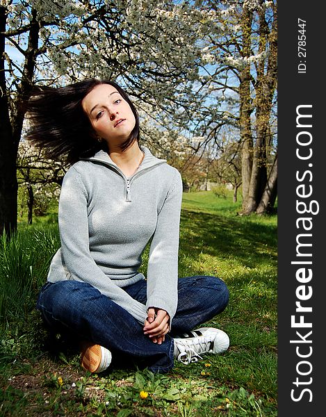 Portrait of a brunette nice girl in a park.