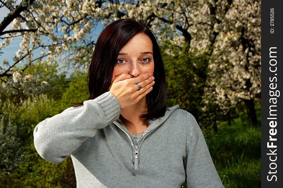 Portrait of a brunette nice girl in a park.