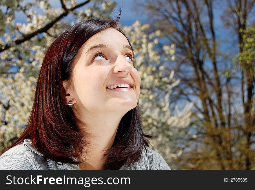 Portrait of a brunette nice girl in a park.