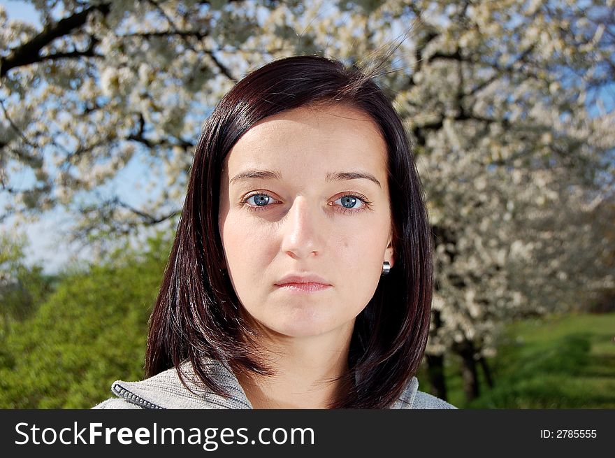 Portrait of a brunette nice girl in a park.