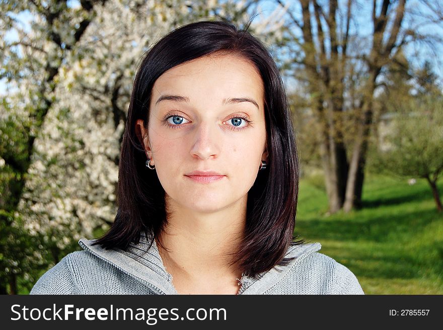 Portrait of a brunette nice girl in a park.