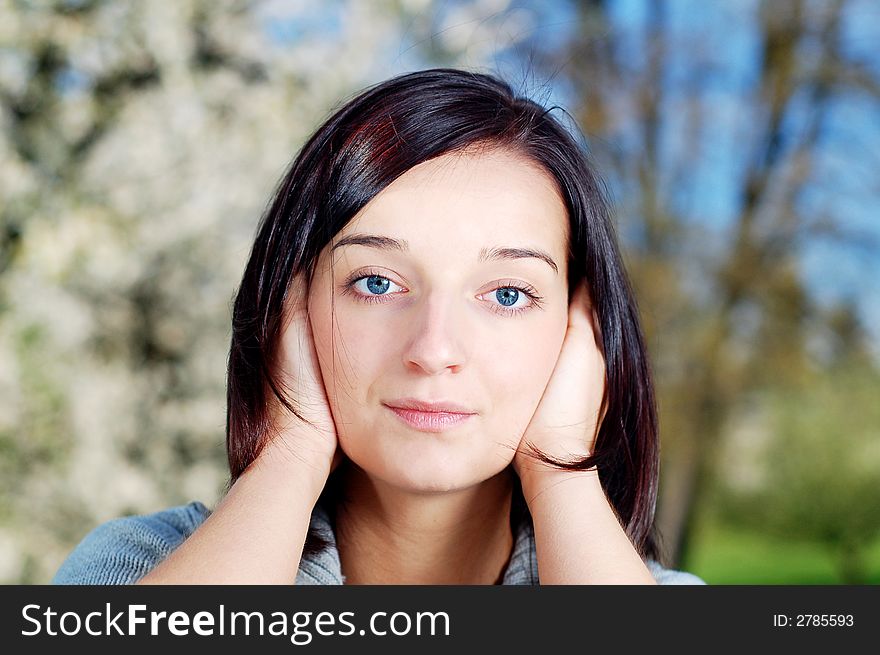 Portrait of a brunette nice girl in a park.