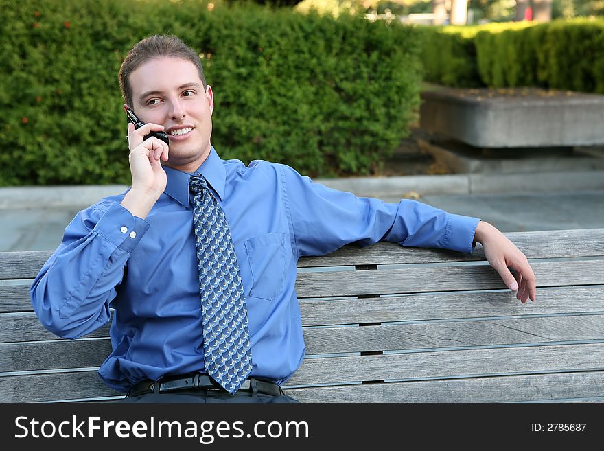 A handsome business man talking on a cell phone