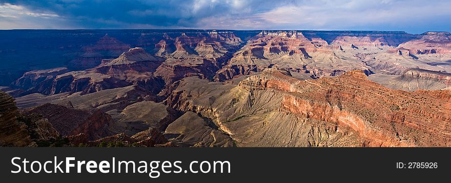 Panorama view of Grand Canyon late evening, storm clouds and shadows. Panorama view of Grand Canyon late evening, storm clouds and shadows