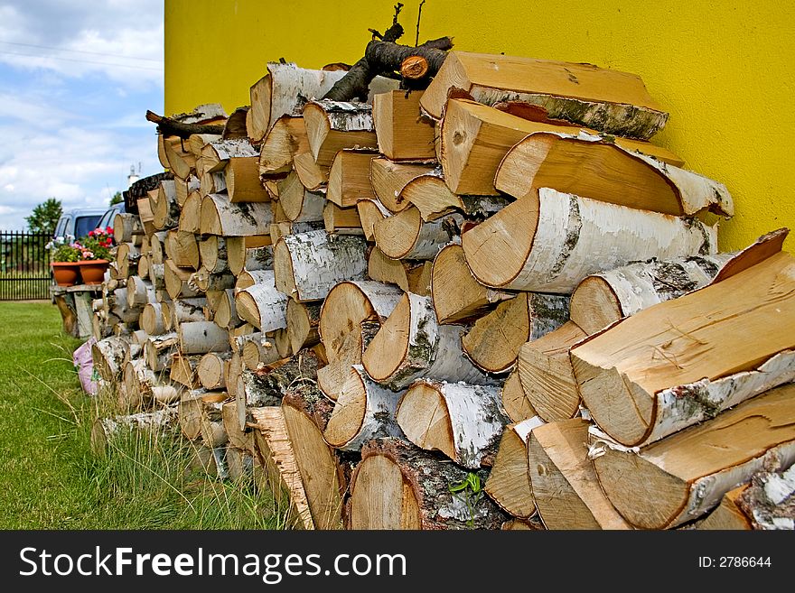 A pile of irregularly stacked pieces of firewood. A pile of irregularly stacked pieces of firewood