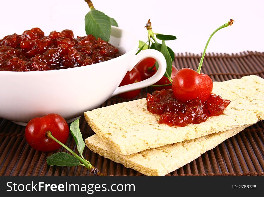 Red cherry jam isolated on white -brown. Red cherry jam isolated on white -brown