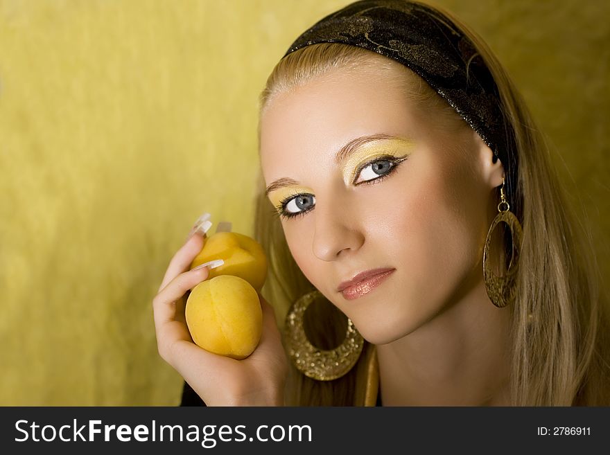 Portrait of young beautiful blond girl with apricot