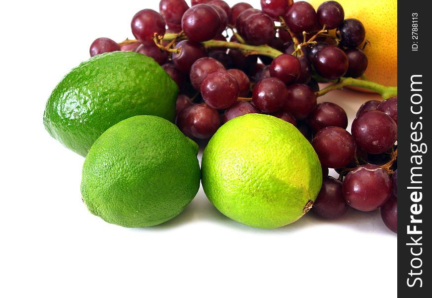 Many fruits on white background (lime, grapes, orange)