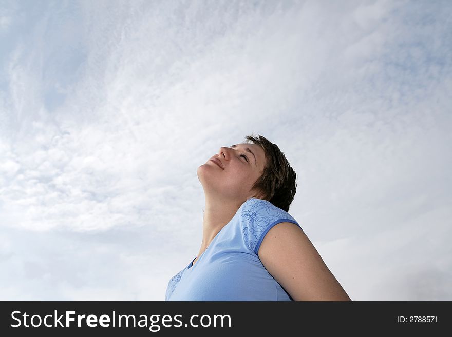 Happy girl on the sky background in summer. Happy girl on the sky background in summer