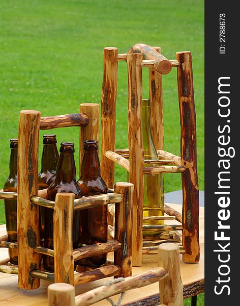 Beer and wine bottles standing in two wooden holders. Beer and wine bottles standing in two wooden holders