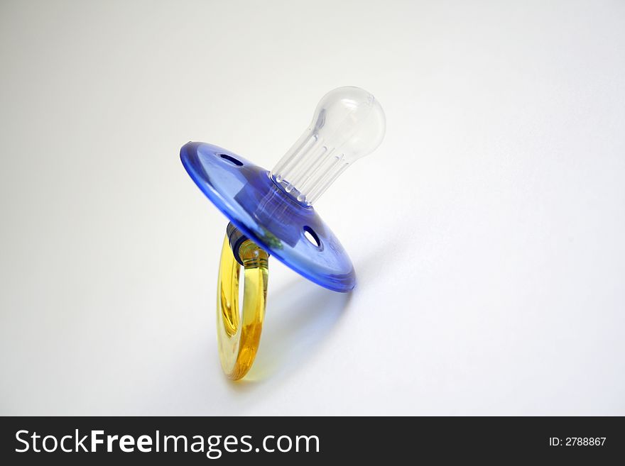 Blue baby pacifier on white background