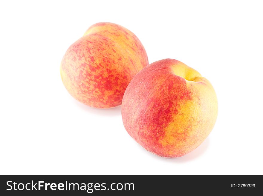 Two peaches isolated on white with small shadows