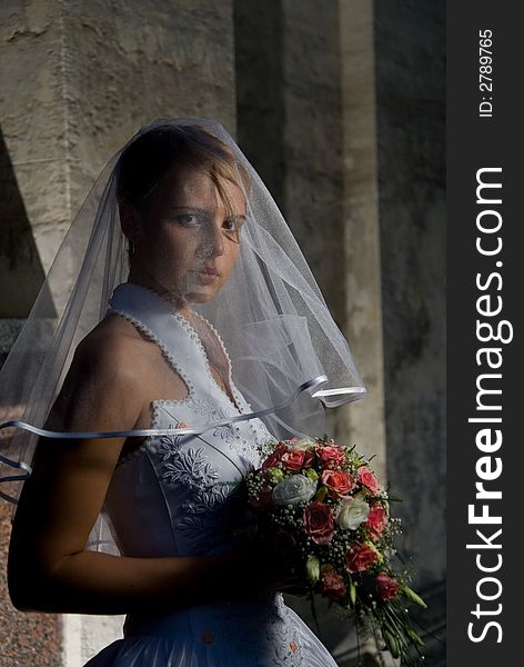 Beautiful bride with a bouquet of roses