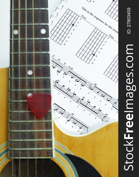 Acoustic Guitar On Music Note Sheet