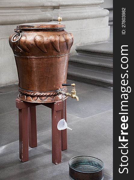 Vintage copper holy water basin in the cathedral. Vintage copper holy water basin in the cathedral