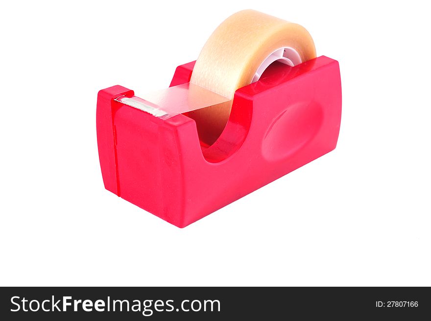 Sticky plastic tape in a roll on the red stand photographed against a white background. Sticky plastic tape in a roll on the red stand photographed against a white background